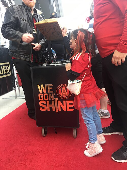 A fan signs the Golden Spike prior to the game on November 11, 2018