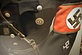 Allgemeine SS black uniform. Closeup of Swastika armband, NSDAP pin, Odal rune Rauter sleeve diamond, Sam Browne belt, etc. Lofoten krigsminnemuseum 2019-05-08 DSC00374.jpg