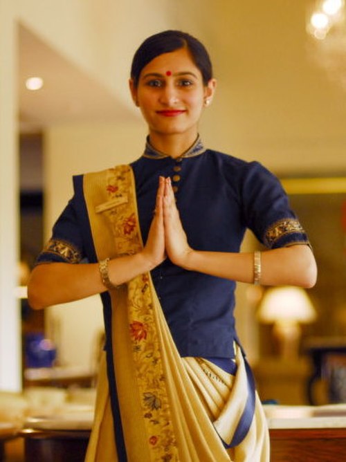 Pressing hands together with a smile to greet Namaste – a common cultural practice in India.