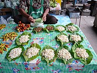 Leaf packets of larvae in Isaan typically sell for about 20 Thai Baht each (about 0.65 USD) Ants Eggs Market Thailand.jpg