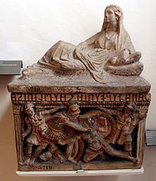 Etruscan funerary urn crowned with the sculpture of a woman and a front-panel relief showing two warriors fighting, polychrome terracotta, c. 150 BCE Arte etrusca, urna cineraria in terracotta con policromia forse autentica, 150 ac ca. 02.JPG