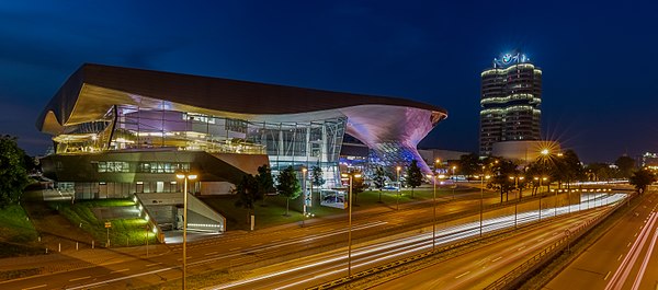 Night view of the BMW Welt and the BMW Headquarters, known as the "4 Cylinders", Munich, Germany.