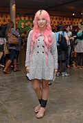 Brazilian hipster girl wearing leg warmers and knitted sweater dress, also sporting vibrant hair