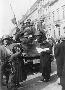 Members of a Freikorps unit with swastikas on their helmets distributing leaflets during the Kapp Putsch Bundesarchiv Bild 183-R16976, Kapp-Putsch, Berlin.jpg