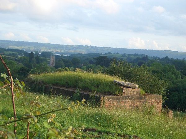 World War II pill box in field north of Chew Magna with view southwards of the parish church and Chew Valley Lake (pictured 2011)