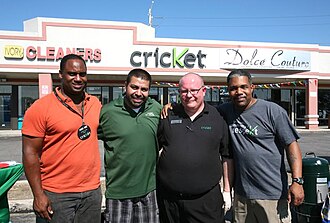 Jonathan Jackson, left in orange, during a cookout at his Cricket Wireless store on 55th St., Chicago Cookout at Cricket Wireless on 55th.jpg