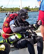 Technical diver with back mounted open circuit scuba and sling mounted decompression cylinders