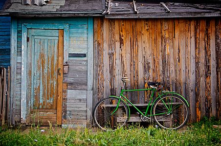 Green bike on a wooden wall