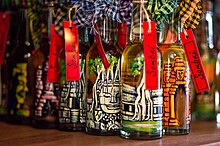 Bottles of Sombai infused rice wine with hand-painted images of Angkor temples Hand-painted bottles of Sombai Liqueur.jpg