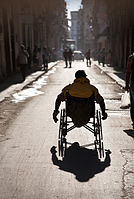 Street life: A handicapped man runs along at sundown. Havana (La Habana), Cuba
