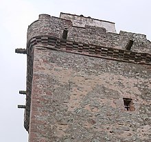 Gargoyles, carved to resemble cannon, project from the parapet HillsTowerSpouts.jpg