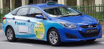 A taxicab with an advertisement for Daikin in Singapore. Buses and other vehicles are popular media for advertisers.