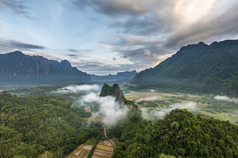 File:Karst peaks mist and colorful clouds at sunrise seen from Mount Nam Xay in Vang Vieng Laos.jpg