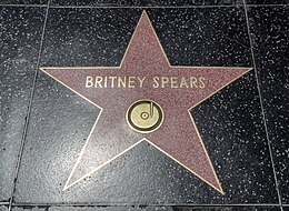 The monuments of Spears are coral-pink terrazzo five-point stars rimmed with brass (not bronze, an oft-repeated inaccuracy) inlaid into a charcoal-colored terrazzo background