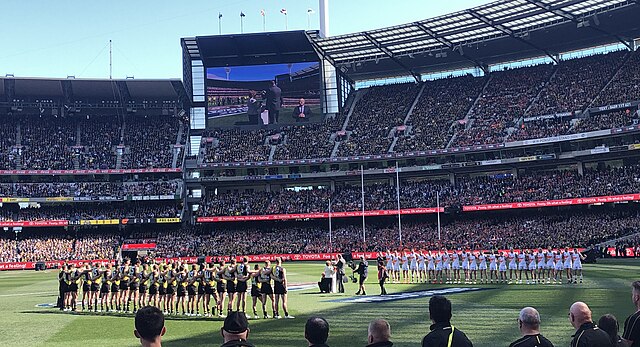The teams line up for the National Anthem at the 2019 AFL Grand Final