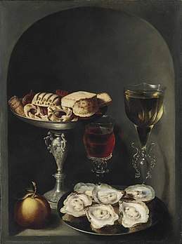 Still life with oysters on a pewter plate and wine glasses in a niche