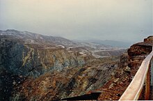 Mountains near Queenstown, Tasmania, completely denuded of vegetation through effects of mining Queenstown minesite area 1984.jpg