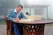 President Ronald Reagan signing the Economic Recovery Tax Act of 1981 and the Omnibus Budget Reconciliation Act of 1981 at his Santa Barbara, California ranch, Rancho del Cielo, 13 August 1981. Photograph by official White House photographer, Karl Schumacher, courtesy of the Ronald Reagan Presidential Library (C03490-4A, https://www.reaganlibrary.gov/archives/photo/c03490-01).