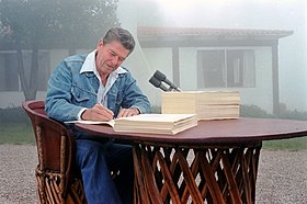 President Ronald Reagan signing the Economic Recovery Tax Act of 1981 and the Omnibus Budget Reconciliation Act of 1981 at his Santa Barbara, California ranch, Rancho del Cielo, 13 August 1981. Photograph by official White House photographer, Karl Schumacher, courtesy of the Ronald Reagan Presidential Library (C03490-4A, https://www.reaganlibrary.gov/archives/photo/c03490-01). Ronald-Reagan-ERTA-Omnibus-Budget-Rancho-del-Cielo-13-Aug-1981-NARA-C3490-4A.jpg