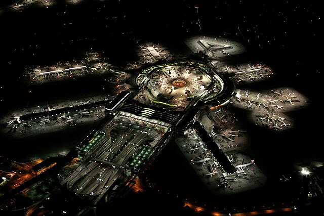 San Francisco International Airport at night, with departure gates radiating out from the terminal building, aerobridges, apron and parked planes