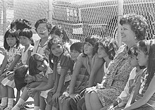 A school principal with a diverse group of students during school integration, 1980. School principal Julia M. Tyler with diverse group of students during school integration, 1980.jpg