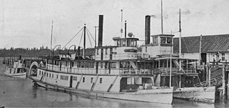 Multnomah (on right) and S.G. Simpson (left) at dock in Olympia, circa 1911, with unidentified smaller steamer approaching at far left Sternwheelers Simpson and Multnomah at Olympia 1911.jpg