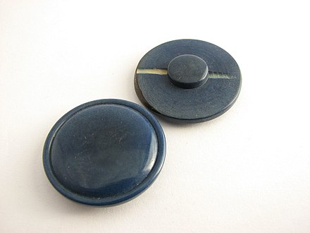 These tagua nut buttons reveal the grain on the top. The carved hole in the shank is the natural color.