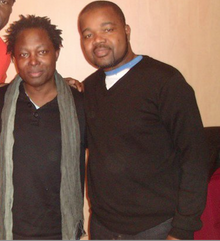 Lokua Kanza (left), January 2013 Ted et Lokua akenza.png