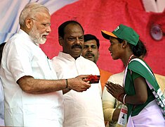 : The Prime Minister, Shri Narendra Modi distributing the smart mobile phones to women entrepreneurs of Sakhi Mandal (SHGs), at a function, at Sahibganj, Jharkhand on April 06, 2017. The Chief Minister of Jharkhand, Shri Raghubar Das is also seen.