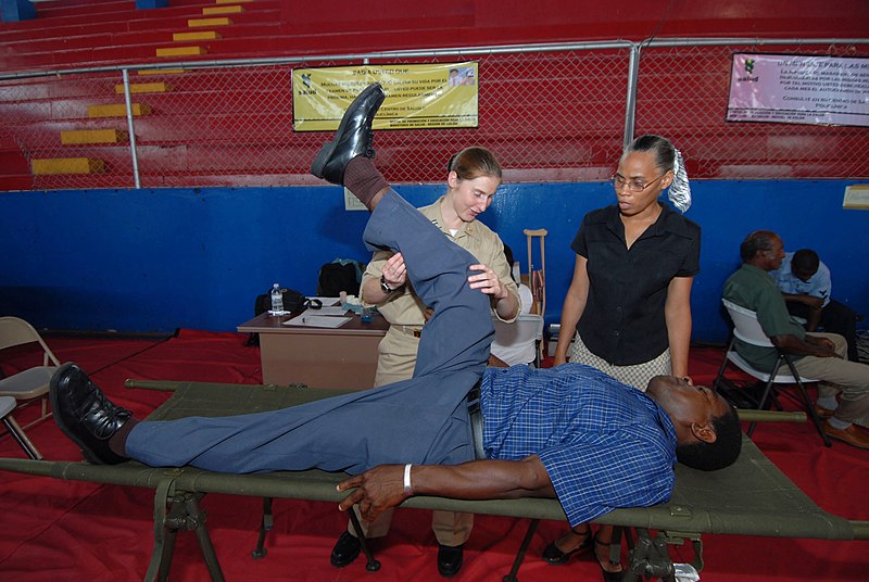 File:US Navy 070706-N-8704K-101 Lt. Gwen Smith, attached to Military Sealift Command hospital ship USNS Comfort (T-AH 20), performs physical therapy with the help of translator Zoela Armstrong at the Paul Brown Arena.jpg