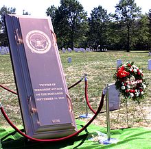 The inscribed cover of the burial vault beneath the monument, on display during the funeral service. Victims of the Terrorist Attack on the Pentagon Memorial - burial vault cover - Arlington National Cemetery - 2002-09-12.jpg