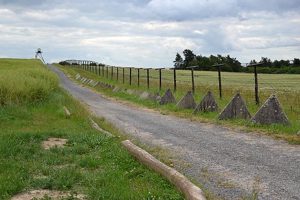 Preserved part of "iron curtain" in the Czech Republic. A watchtower, dragon's teeth and electric security fence are visible.