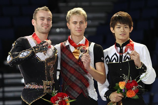 Brezina with the other medalists at the 2011 Skate America