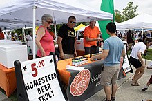 Founders Day volunteers sell beer and other alcoholic beverages in the newly established DORA, 2022.