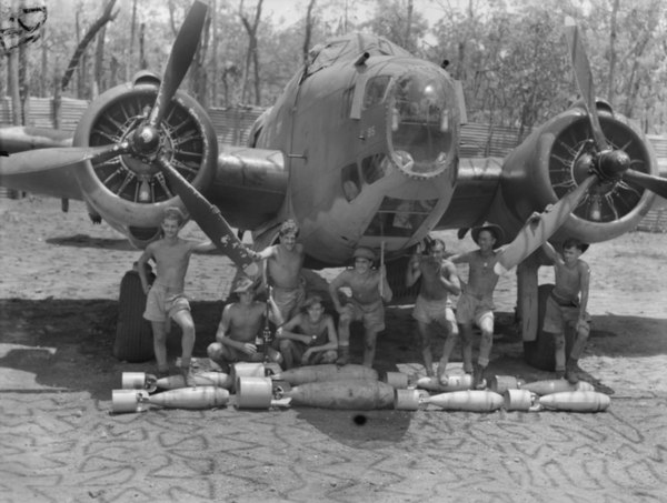 1943. A twin-engine Lockheed Hudson of No. 2 Squadron RAAF. Its crew and ground staff pose for the photographer, prior to loading the Hudson with its 