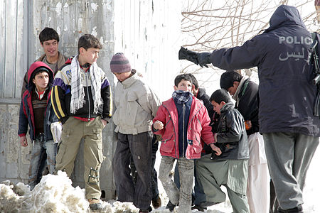 Afghan boys and police in 2010.jpg