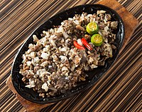 Sisig, usually served in scorching metal plates