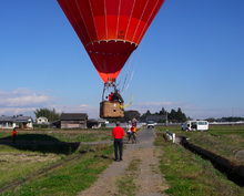 A balloonist prepares to drop a marker on a competition target, in this case the centre of a road intersection. Balloon target.png