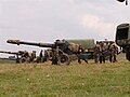 152 mm howitzer M81 towed into position by trucks.