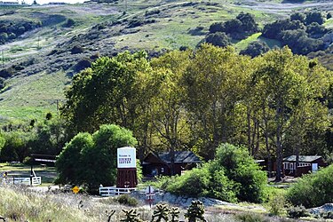 View of the Bommer Canyon Cattle Camp area within the preserve with water tower reading "Welcome to Bommer Canyon." The canyon was utilized as part of the Irvine Company's cattle operations for approximately one hundred years. Bommer Canyon Cattle Camp.jpg