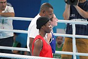 Deutsch: Boxen bei den Olympischen Jugendspielen 2018 Tag 12, 18. Oktober 2018 - Finale Fliegengewicht Mädchen – Martina La Piana (Italien, blau) schlägt Adijat Gbadamosi (Nigeria, rot) 5-0; Ringrichter ist James Beckles (Trinidad und Tobago). English: Boxing at the 2018 Summer Youth Olympics on 18 October 2018 – Girl's flyweight Gold Medal Bout - Martina La Piana (Italy, blue) beats Adijat Gbadamosi (Nigeria, red) 5-0; Referee is James Beckles (Trinidad and Tobago). Español: Boxeo en los Juegos Olímpicos Juveniles de Verano de 2018 en 18 de octubre de 2018 - Combate a medalla de oro de peso mosca para mujeres: Martina La Piana (Italia, azul) le gana a Adijat Gbadamosi (Nigeria, roja) 5-0; El árbitro es James Beckles (Trinidad y Tobago).