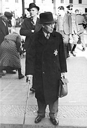 Beginning in 1941, Jews were required by law to self-identify by wearing a yellow badge on their clothing. Bundesarchiv Bild 183-R99993, Jude mit Stern in Berlin.jpg