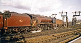 Lokomotive 46238 City of Carlisle 1964 im Bahnhof Chester General. Der gelbe Streifen auf dem Führerstand signalisiert, dass die Lokomotive aufgrund ihres Lichtraumprofils nicht auf elektrifizierten Strecken eingesetzt werden darf.