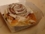 A Cinnabon cinnamon roll in a to-go box Cinnamon roll-Cinnabon.jpg