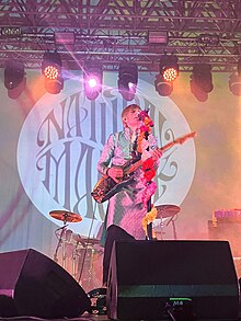 Mills and Winterhart (obscured) performing with the band at Glasgow in 2024 to promote the Natural Magick album Crispian Mills of Kula Shaker in 2024.jpg