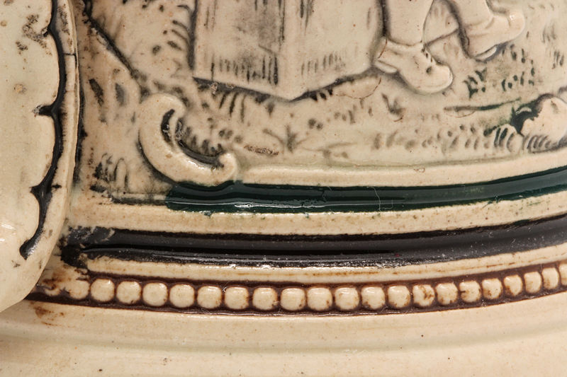 File:Faience beer stein with ball scene on brown background 41.jpg