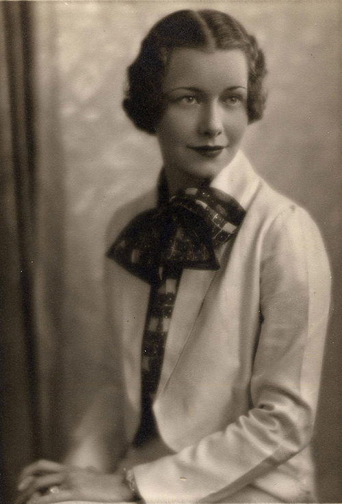 A smart young woman in a lightweight jacket and printed silk blouse. American, 1935.