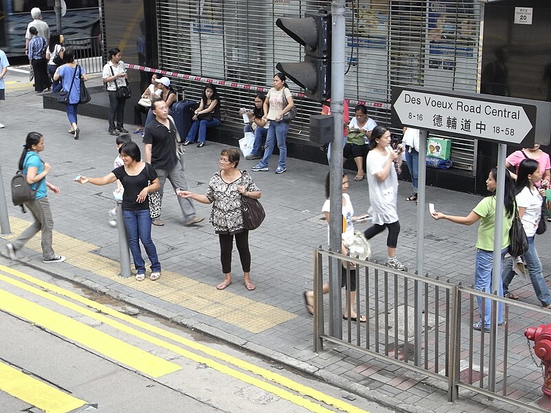 File:HK Tram tour view Central Des Voeux Road sign salesladies.JPG