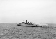 A Seaslug missile roars away from HMS Devonshire's twin launcher for the first time. At this early stage of firing, the boosters can be seen still attached to the weapon, May 1962 HMS Devonshire, 1962 (IWM).jpg