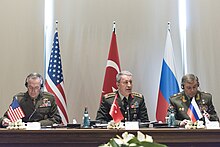 Joseph Dunford, Hulusi Akar and Valery Gerasimov discussing their nations' operations in northern Syria, March 2017 Joseph Dunford, Hulusi Akar and Valery Gerasimov 170307-D-PB383-021 (33179920601).jpg